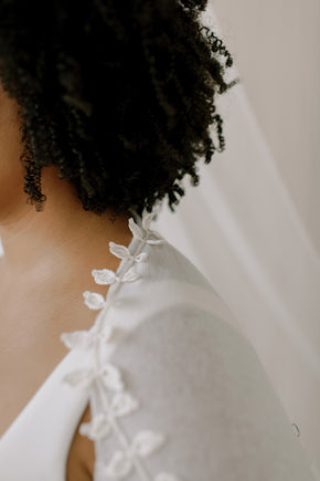 Wedding Shrug made from sustainable 100% Cashmere. Hand crochet silk vines adorn the neckline.  Detail view