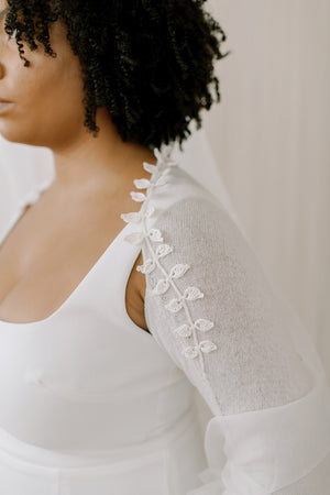 Wedding Shrug made from sustainable 100% Cashmere. Hand crochet silk vines adorn the neckline.  Detail view